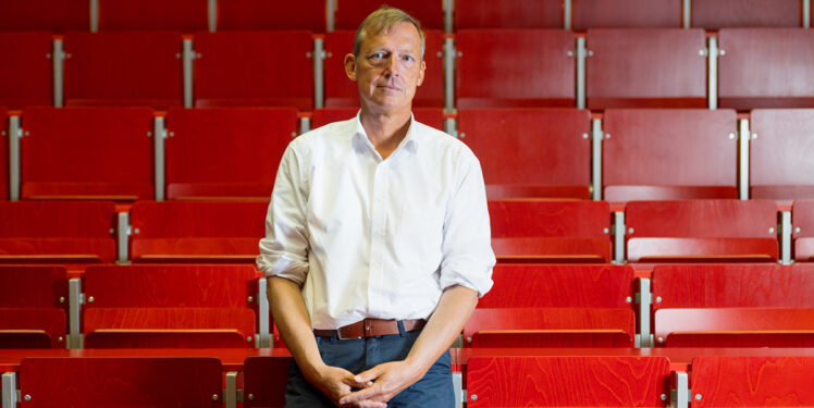 Andreas Reuter vor roten Stühlen